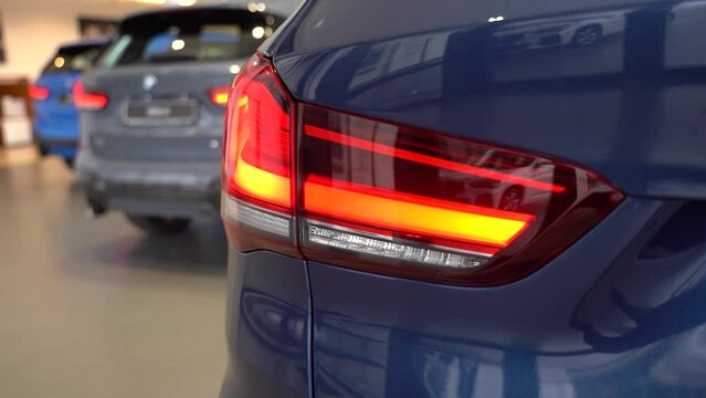 Kyiv, Ukraine - APRIL 12, 2023: Blue BMW X1 left tail light closeup