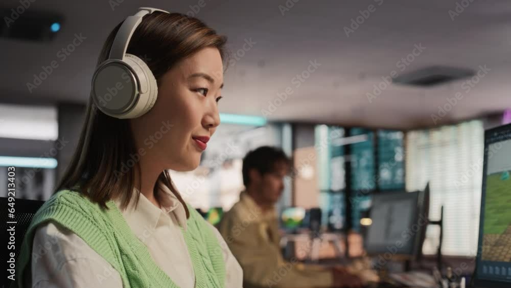 Aufkleber Close Up Of Asian Female Game Designer Using Desktop Computer, Designing Unique World And Characters In 3D modelling Software For Survival Video Game. Woman Working In Game Development Studio Office.