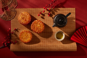 Bamboo blinds featured a tea set in black color and three mooncakes with elegant patterns. Tree...