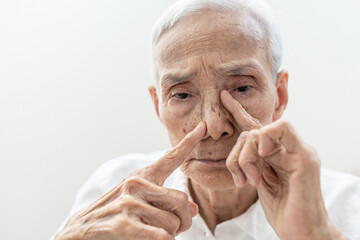 Old elderly suffering Chronic Rhinosinusitis with Nasal Polyps or Sinusitis,cold or sinus infections,nasal congestion,blockage of nose,difficult to breathe through nostrils and reduced sense of smell - obrazy, fototapety, plakaty