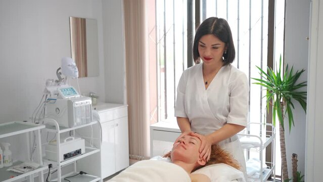 Face massage for woman for glowing, smooth and healthy skincare treatment aesthetic cosmetology salon. Beauty, detox and hands healing young client in a facial physical therapy session
