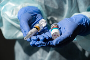 Doctor holds syringe and injection medicine
