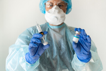 Doctor holds syringe and injection medicine