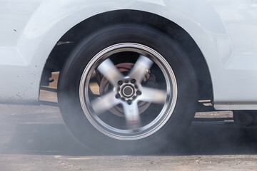 Close up car wheel with smoke on the asphalt road speed track, Car wheel drifting and smoking on...