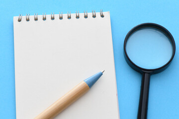 Blank notepad and on office blue table