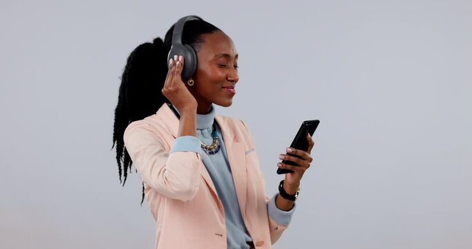 Business woman, phone and headphones, singing or happy music on streaming service and premium subscription in studio. African worker listening to audio electronics or mobile radio on white background
