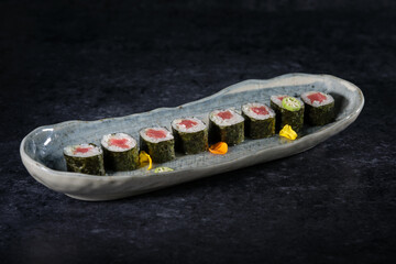 Delicious sushi rolls with salmon served on marble tray