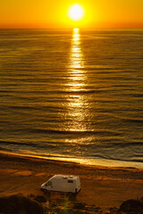 Camper van on beach at sunrise