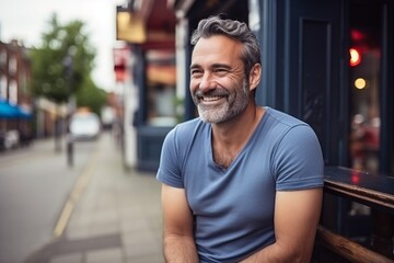Fototapeta premium Portrait of handsome middle-aged man smiling at the camera outdoors