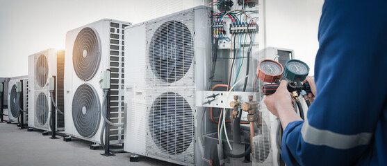 Technician is checking air conditioner,measuring equipment for filling air conditioners.