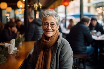 Portrait of happy senior woman sitting in a cafe in Paris, France