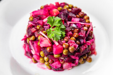 beet salad vegetables peas, carrots, potatoes, onions, pickled cucumber appetizer meal food snack on the table copy space food background rustic top view keto or paleo diet vegetarian vegan food