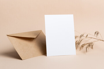 Blank greeting card mockup with envelope and dry trendy botanical decor