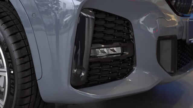 Kyiv, Ukraine - APRIL 12, 2023: Grey BMW X1 xDrive20i Fog light closeup