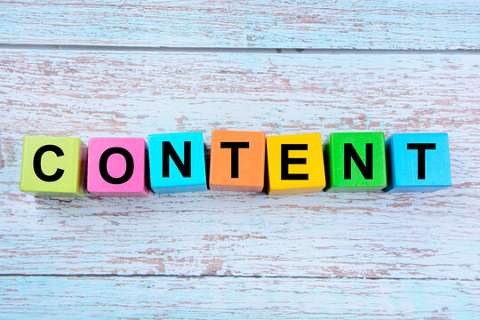 The word Content on wooden cubes on a blue table