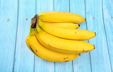 Group of bananas on a blue wooden background