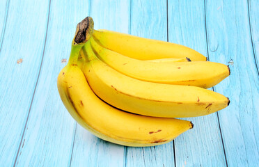 Ripe bananas on a blue wooden background