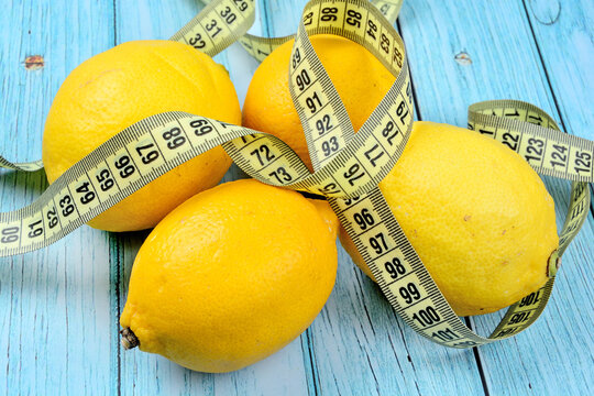Lemons on the the table with a tape measure for measuring