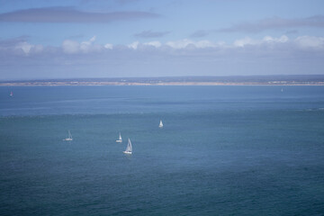 White yachts sailing in the calm sea on a sunny day