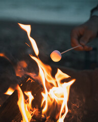 Marshmallows being toasted on a camp fire