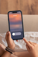 Smartphone in child hands with Incoming mommy call on a screen.