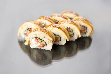 Sushi rolls on white background with reflection, space for text. Japanese food