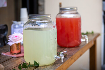 Glass juice fountain with lemon and watermelon juice