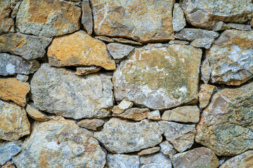 Closeup view of ancient dry stone wall  - a natural textured background