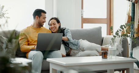 Couple, laptop and laugh on sofa in home for meme, watch movies and streaming funny multimedia....