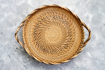 round rattan basket isolated on wooden background