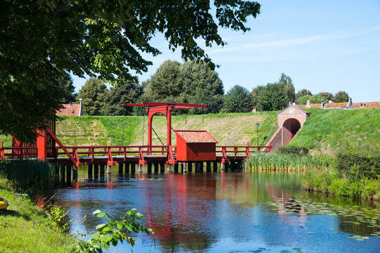 the typican red color of the bridges in bourtange in the netherlands, a old fortress touristic town