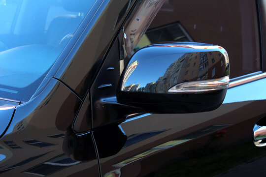 Close up of Black rear-view mirror of automobile, side mirror of SUV and Luxury car, car wing mirror, Left side turn signal.