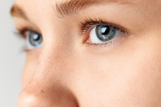Close-up image of female face, eyes looking away. Beautiful blue eyes. Vision, health care
