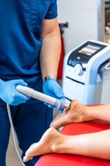 Patient getting non-surgical treatment with shock waves for plantar fasciitis.