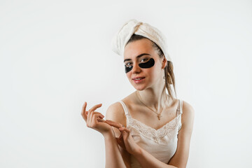 Caucasian woman touching glowing skin face with hydrogel patches under eyes isolated on white