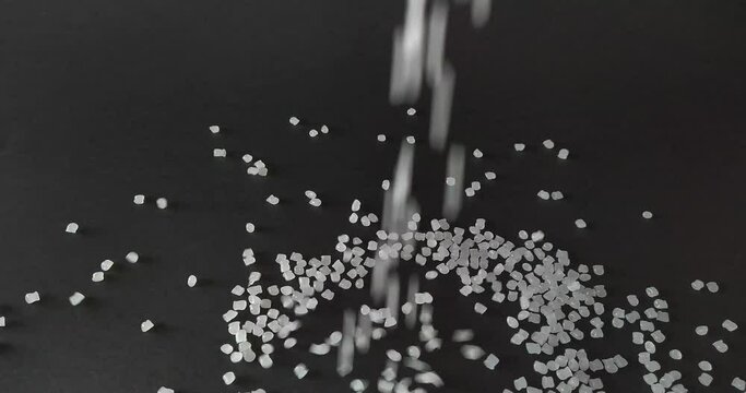 polyethylene pellets dropping and piling up on the table