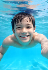Fototapeta na wymiar little child happy in swimming pool, school boy enjoy and smiling in underwater, kid swimming, teenage boy enjoy his life
