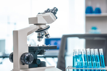 Medical Research Lab Interior with Microscope, close up shot modern medical research laboratory, prominent microscope, neatly arranged test tubes, highlighting pursuit of groundbreaking discoveries.