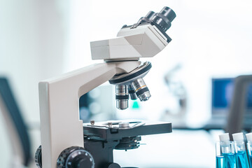 Medical Research Lab Interior with Microscope, close up shot modern medical research laboratory, prominent microscope, neatly arranged test tubes, highlighting pursuit of groundbreaking discoveries.