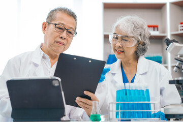Senior scientists analyzing pharmaceuticals, asian people, senior man and woman, experienced...