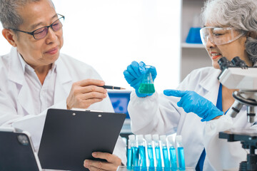 Senior scientists analyzing pharmaceuticals, asian people, senior man and woman, experienced...