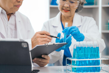 Senior scientists analyzing pharmaceuticals, asian people, senior man and woman, experienced...