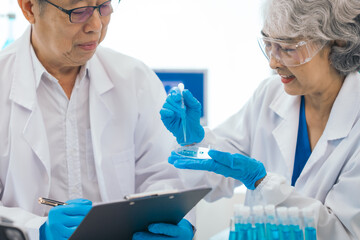 Senior scientists analyzing pharmaceuticals, asian people, senior man and woman, experienced...