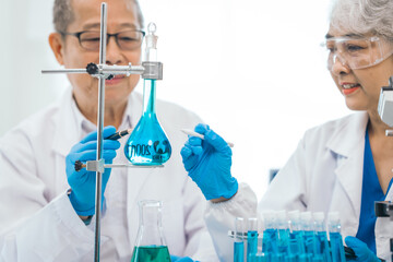 Senior scientists analyzing pharmaceuticals, asian people, senior man and woman, experienced...
