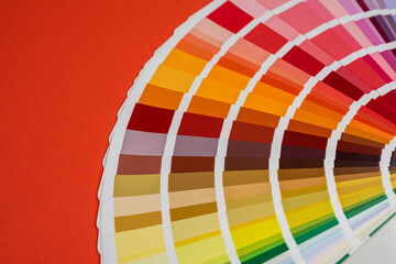 Paper rainbow color palette guide isolated on red background