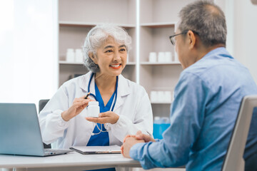 Fototapeta premium Elderly patient asian people attentively listening to mature doctor, receiving valuable health advice and discussing comprehensive health results in caring medical environment. Health Consultation