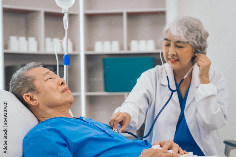 Wall mural Senior elderly male patient and asian people mature woman doctor, showcasing importance of healthcare expertise and patient support. caring senior doctor assisting elderly patient in hospital bed