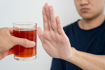 man refuses say no and avoid to drink an alcohol whiskey , stopping hand sign male, alcoholism treatment, alcohol addiction, quit booze, Stop Drinking Alcohol. Refuse Glass liquor, unhealthy, reject