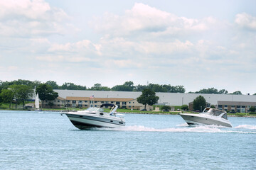 two cabin cruiser boats speeding on st clair river in ontario - 649315627