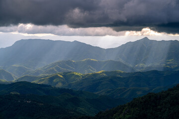 Beautiful mountain range with thunder storm and sun light in Tak province of Thailand